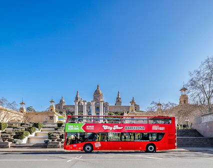 Red double-decker bus in front of the National Palace, Barcelona.