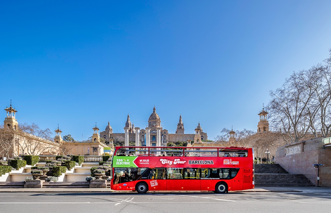 Barcelona hop-on hop-off bus passing Sagrada Familia.
