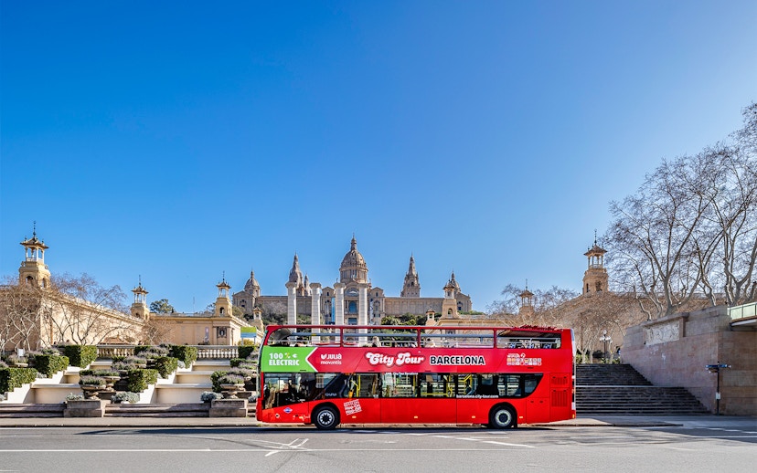 Red double-decker bus in front of the National Palace, Barcelona.