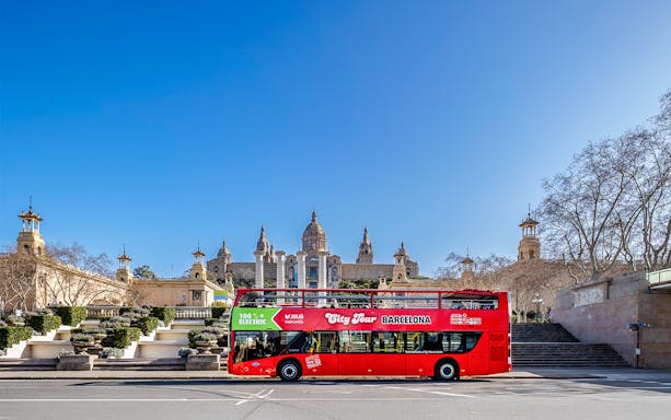 Red double-decker bus in front of the National Palace, Barcelona.