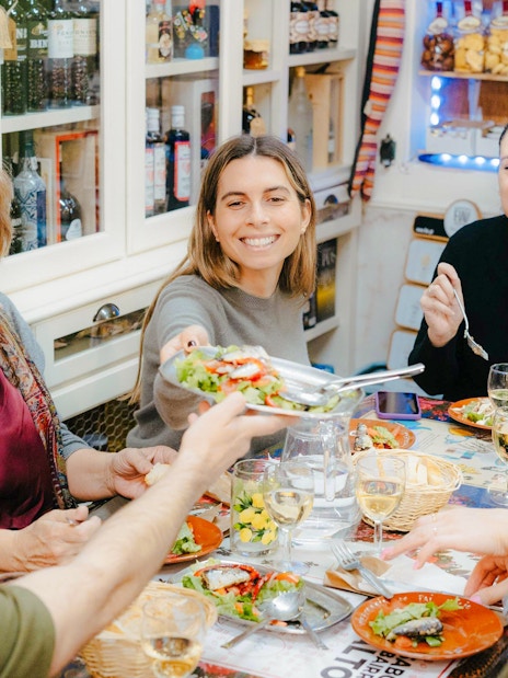 People enjoying a meal together on a Lisbon food tour.