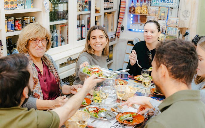 People enjoying a meal together on a Lisbon food tour.