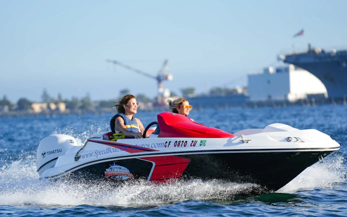 Two people enjoying a speed boat ride on San Diego Bay.