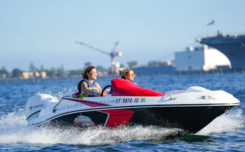 Two people enjoying a speed boat ride on San Diego Bay.