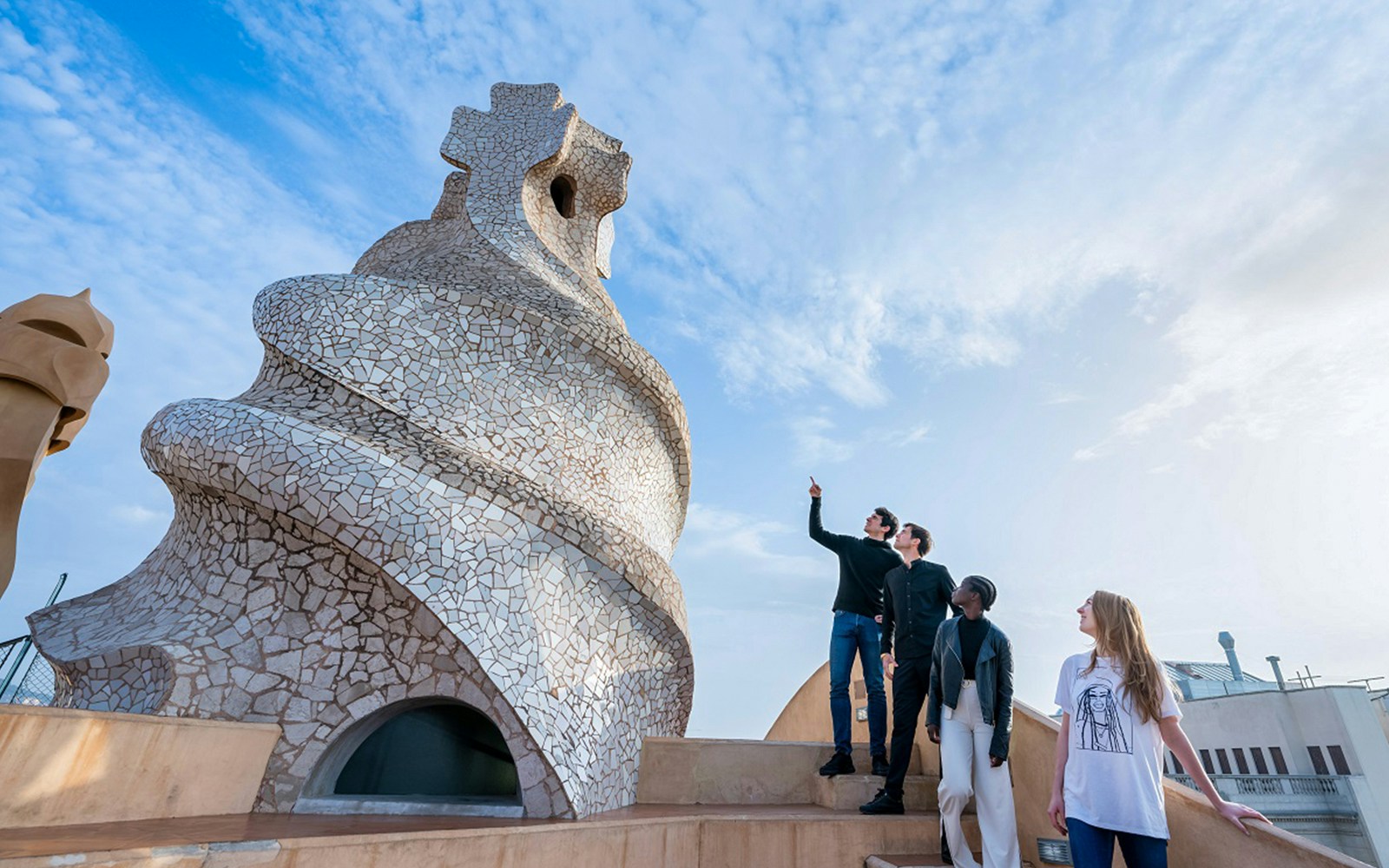 Visitors exploring the unique chimneys on La Pedrera-Casa Milà terrace in Barcelona.