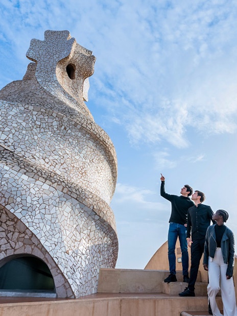Visitors exploring the unique chimneys on La Pedrera-Casa Milà terrace in Barcelona.