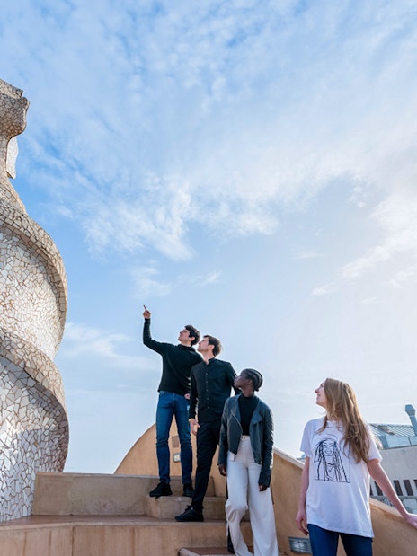 Visitors exploring the unique chimneys on La Pedrera-Casa Milà terrace in Barcelona.