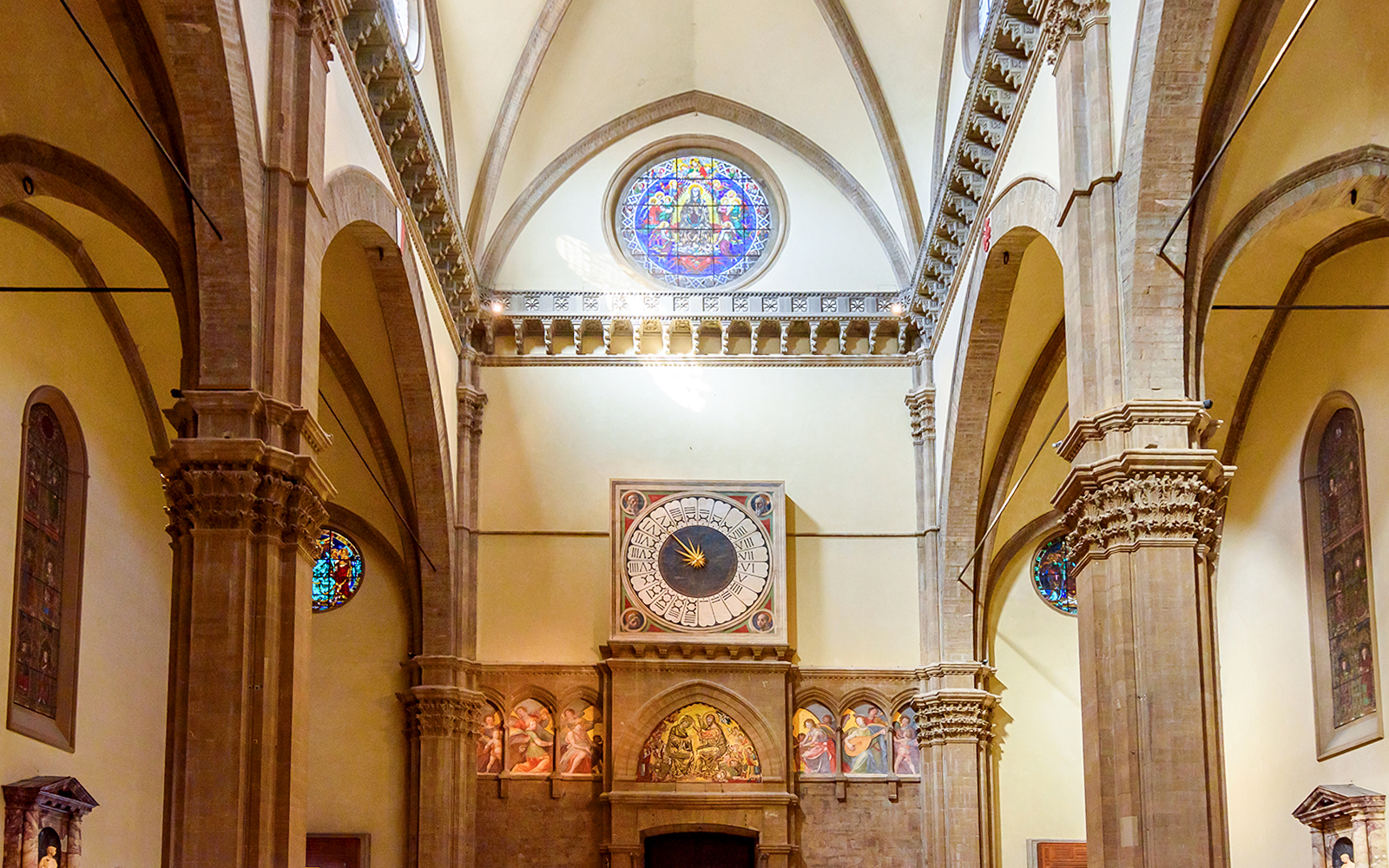 Florence Cathedral interior with ornate columns and a historic clock.