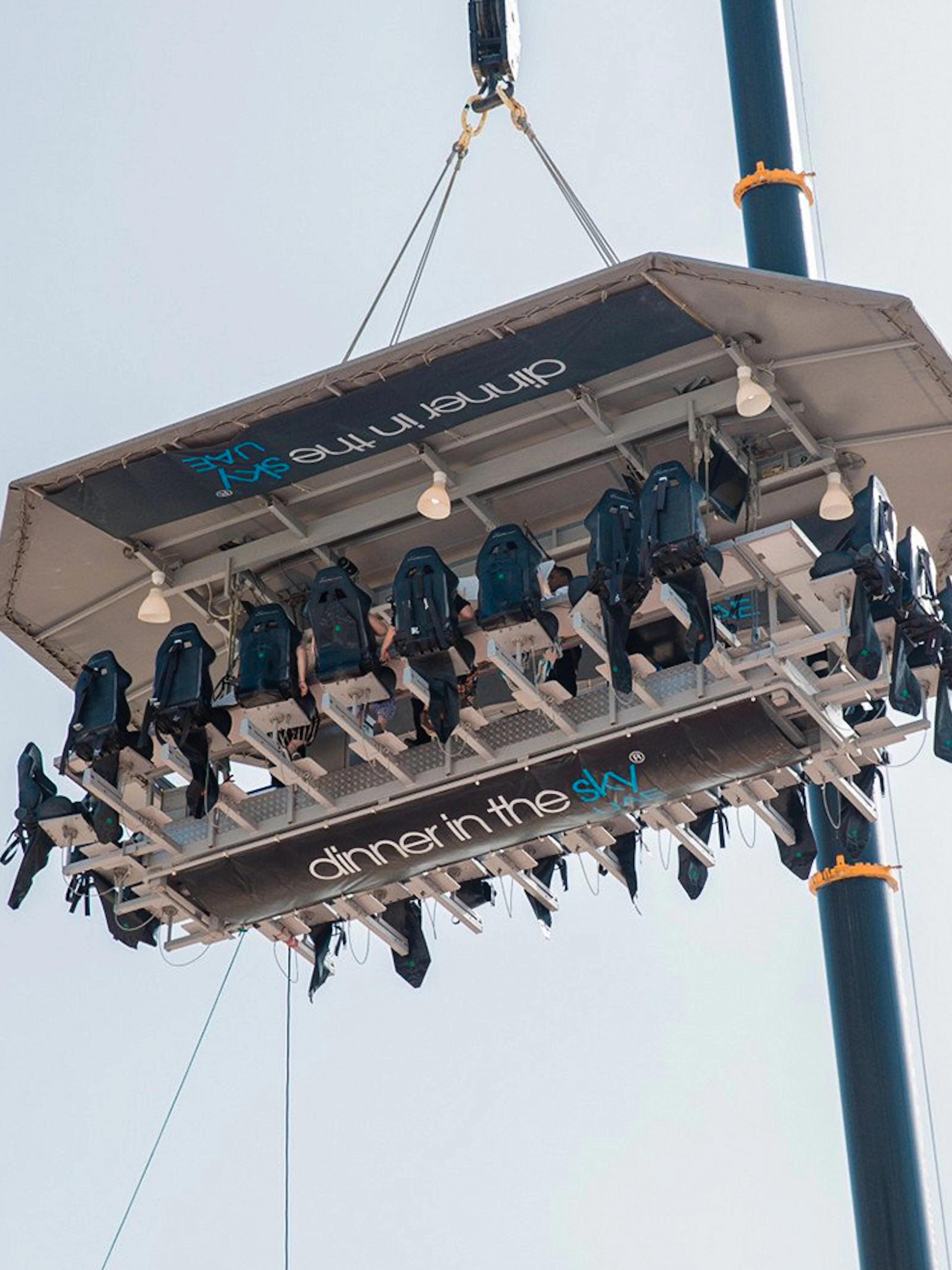 Guests dining on a suspended platform for Dinner in the Sky experience.