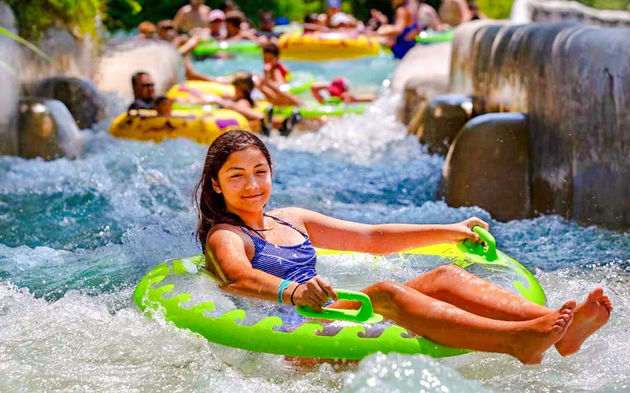 Tubing adventure at The Falls, Schlitterbahn New Braunfels, with people enjoying the water ride.