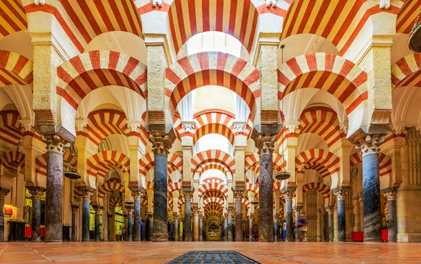 Cordoba Mosque-Cathedral prayer hall with red and white arches.