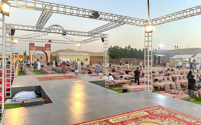 Evening desert safari setup with seating and stage in Dubai.