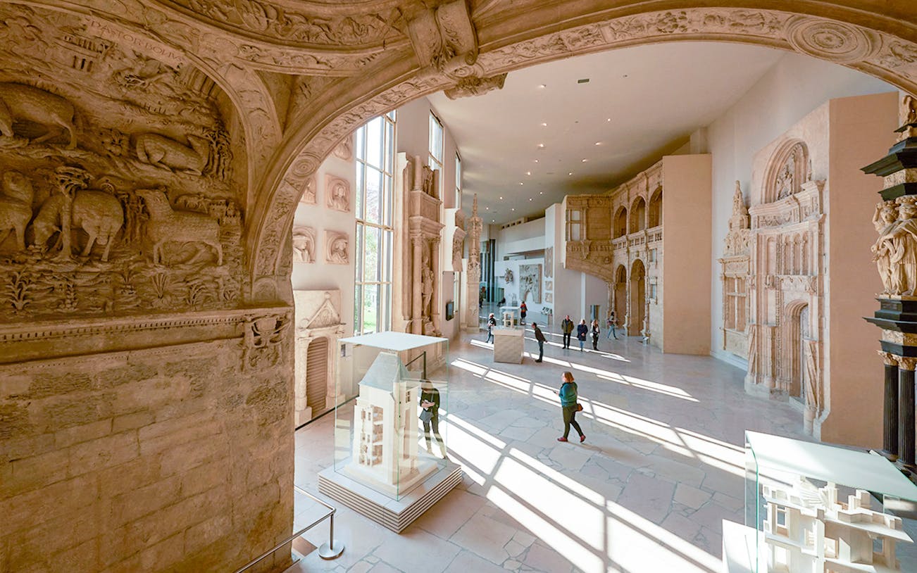 Notre-Dame de Paris exhibition at City of Architecture & Heritage, showcasing detailed architectural models and sculptures.