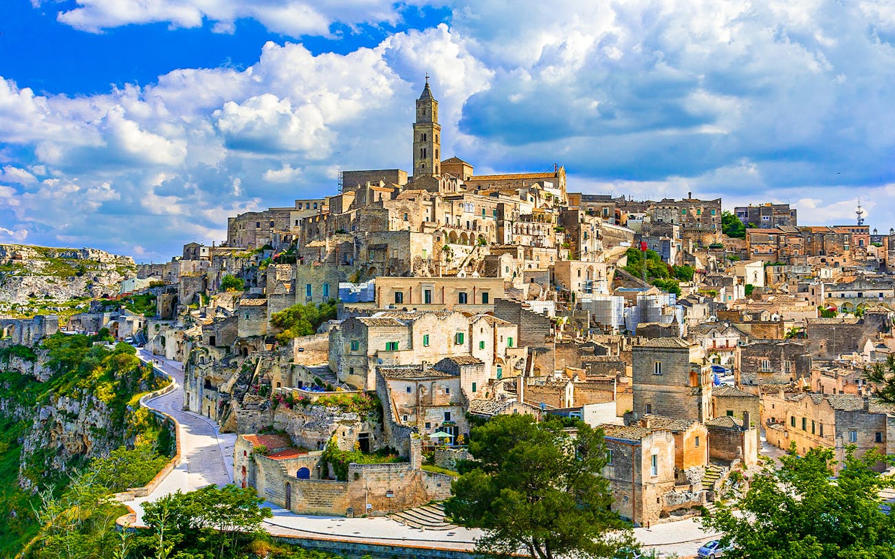 Sassi of Matera ancient stone buildings under a blue sky, Italy.