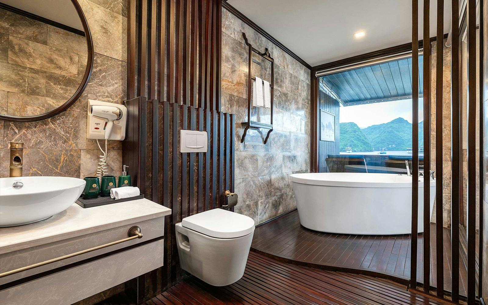 Luxurious bathroom with a freestanding tub and ocean view in the Royal Suite at Amanda Luxury Cruise.