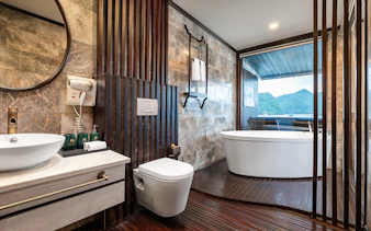 Luxurious bathroom with a freestanding tub and ocean view in the Royal Suite at Amanda Luxury Cruise.