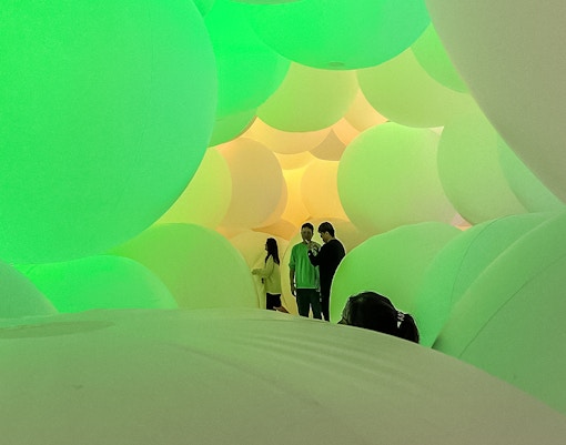 Visitors exploring the expanding three-dimensional space at TeamLab exhibit in Tokyo