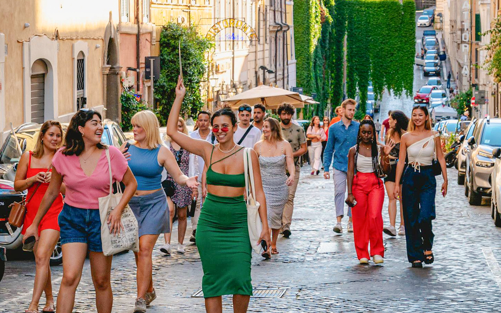 Tourists walking on a cobblestone street in Rome.