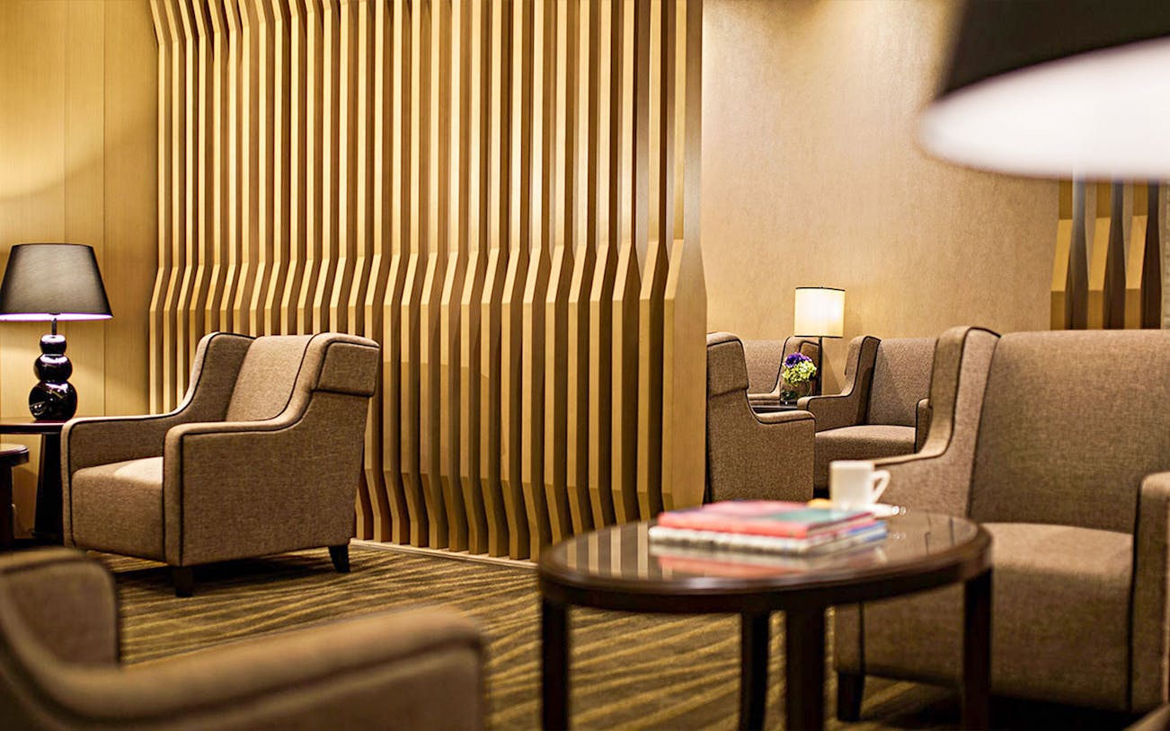 Plaza Premium First lounge seating area with modern decor and ambient lighting.