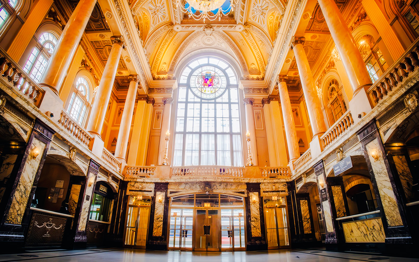 Chicago Theatre interior with ornate columns and stained glass window.