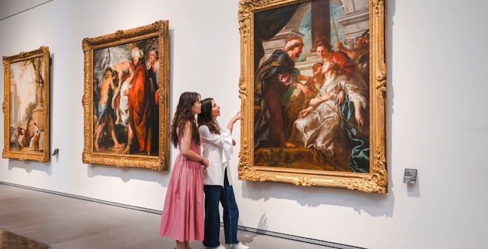 Women admiring Rubens' "The Education of the Virgin" at Louvre Abu Dhabi.