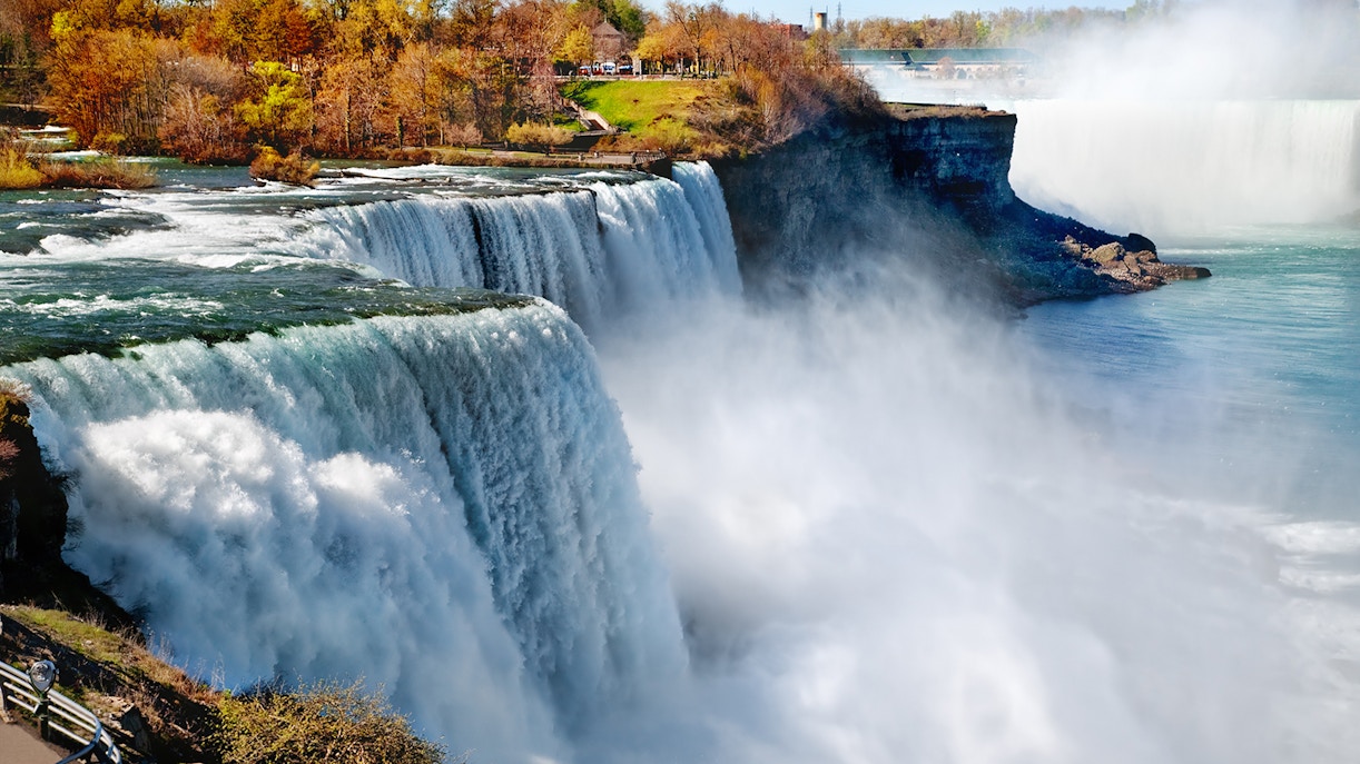 Niagara Falls view with mist rising, showcasing the iconic waterfall on the Canada-USA border.