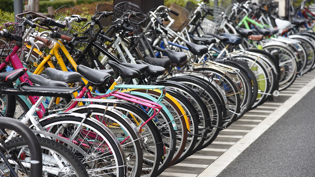Bicycles lined up in a parking lot.