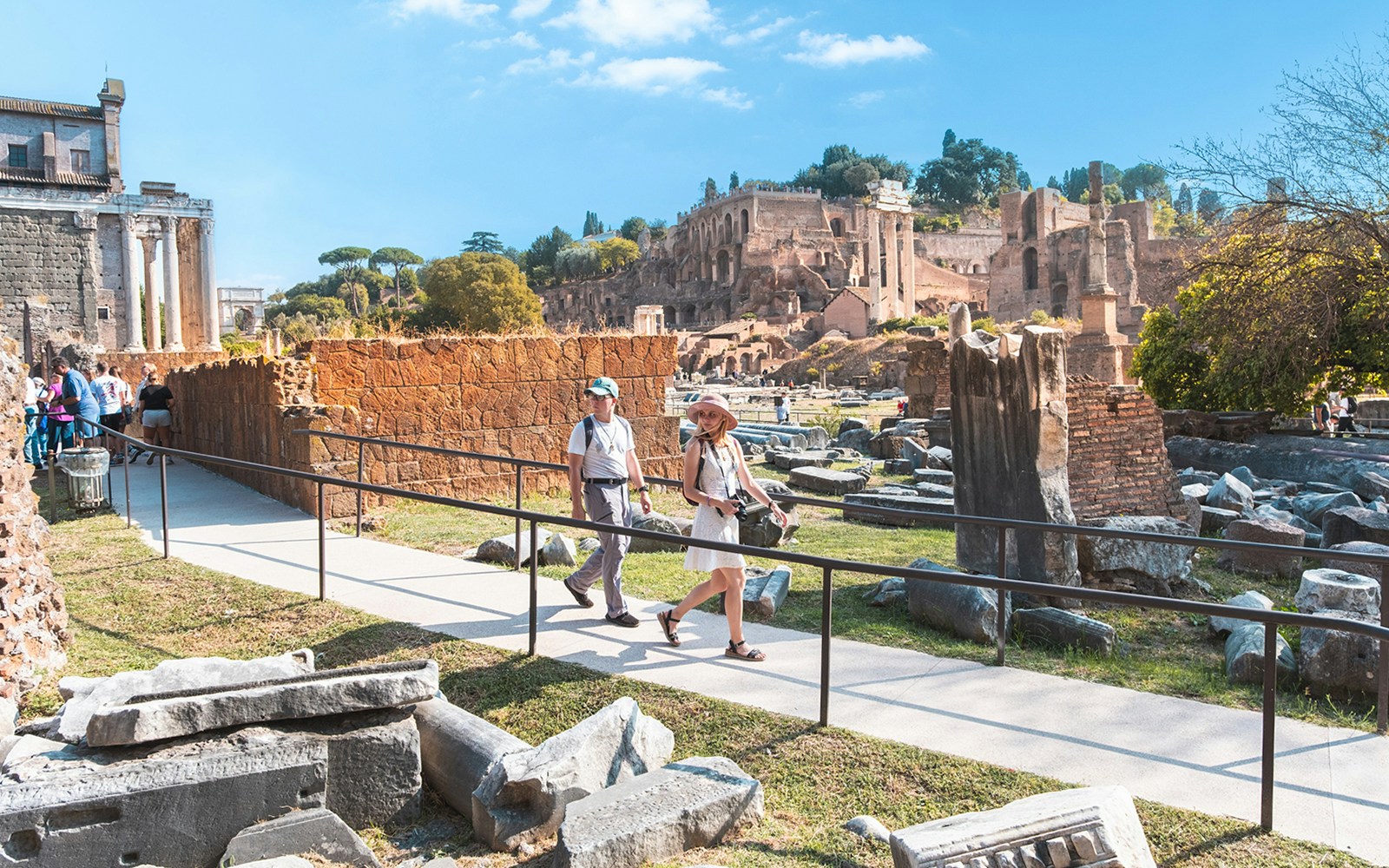 Visitors walking through the Roman Forum ruins in Rome.