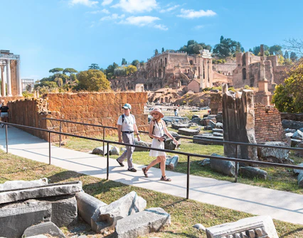 Visitors walking through the Roman Forum ruins in Rome.