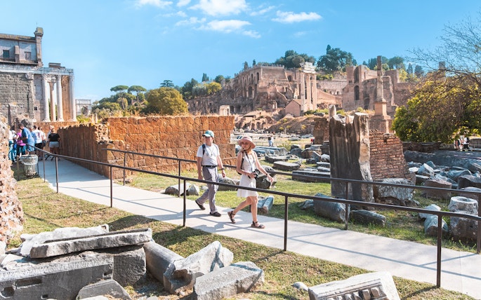 Visitors walking through the Roman Forum ruins in Rome.