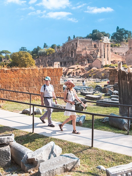 Visitors walking through the Roman Forum ruins in Rome.