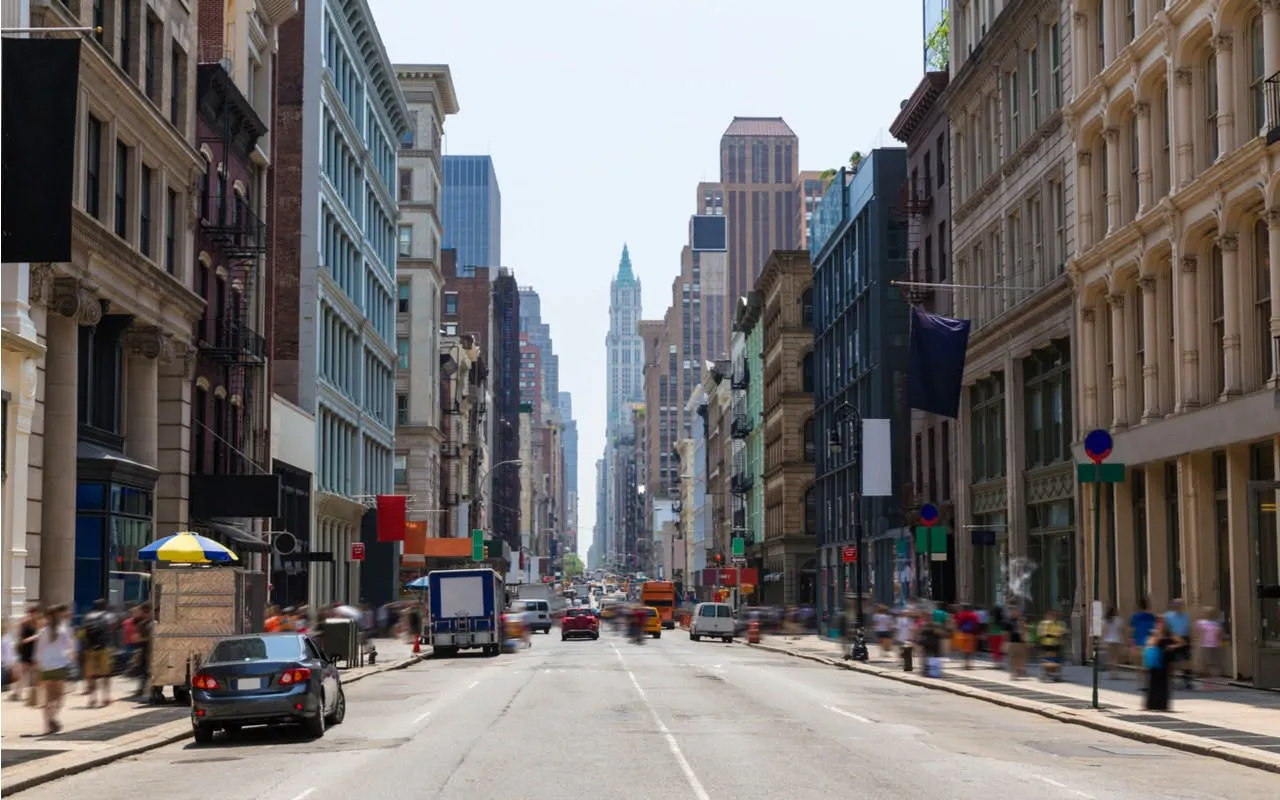 Busy New York City street with historic buildings, part of a self-guided superhero exploration game.