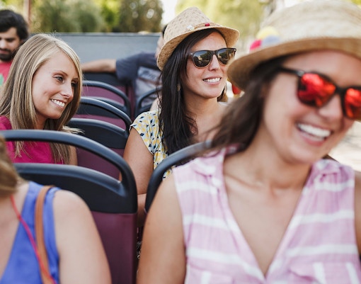People happily conversing on the upper deck of Hop On Hop Off Bus Tour.