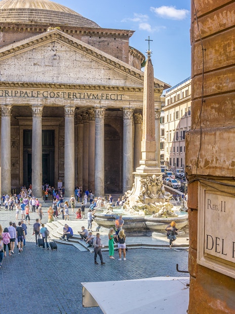 Pantheon in Rome with tourists and fountain in the foreground.