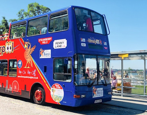 Women on top deck on bus listening to audioguide