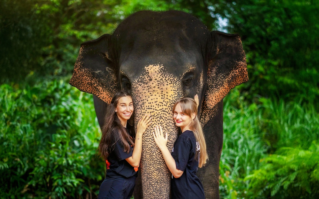 Women with elephant at Elephant Jungle Sanctuary, Phuket, Thailand.