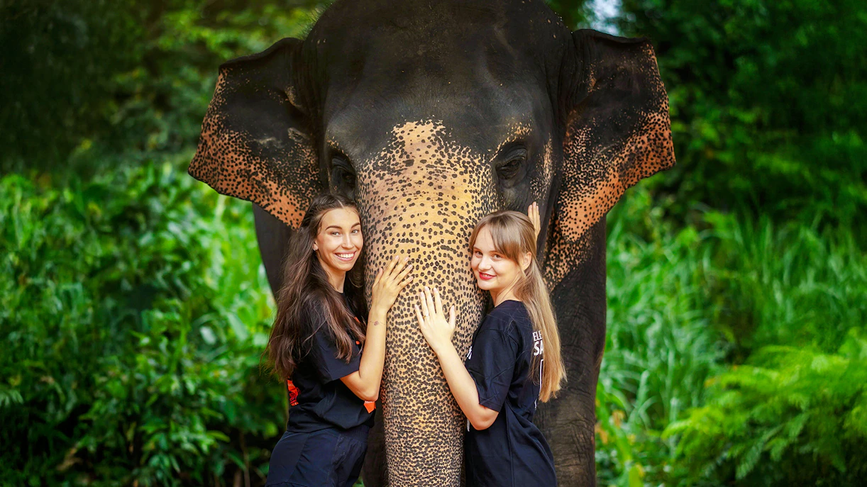 Women with elephant at Elephant Jungle Sanctuary, Phuket, Thailand.