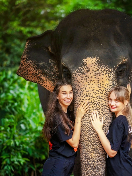 Women with elephant at Elephant Jungle Sanctuary, Phuket, Thailand.