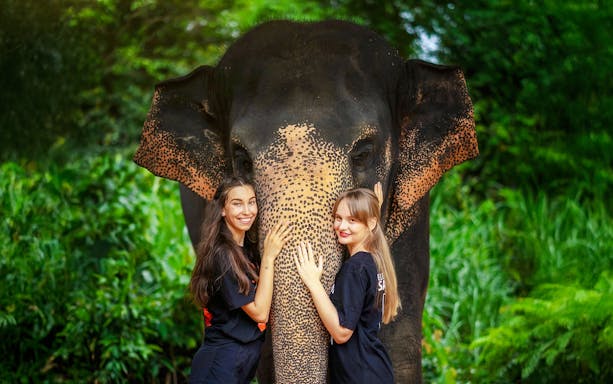 Women with elephant at Elephant Jungle Sanctuary, Phuket, Thailand.
