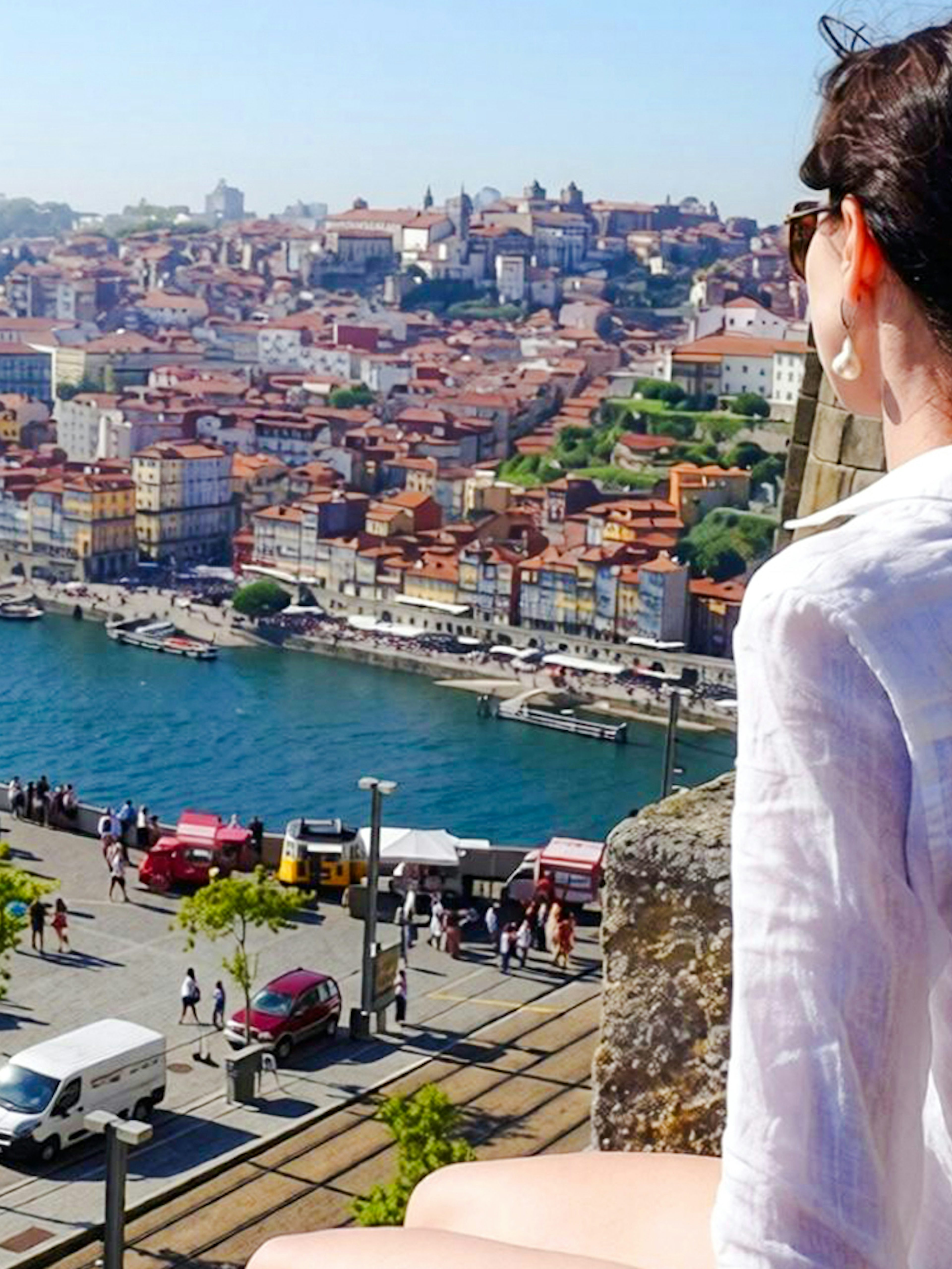 Person overlooking the Douro River and Porto cityscape in Portugal.