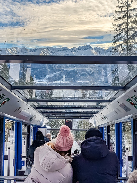 Couple enjoying mountain views inside Zakopane cable car.