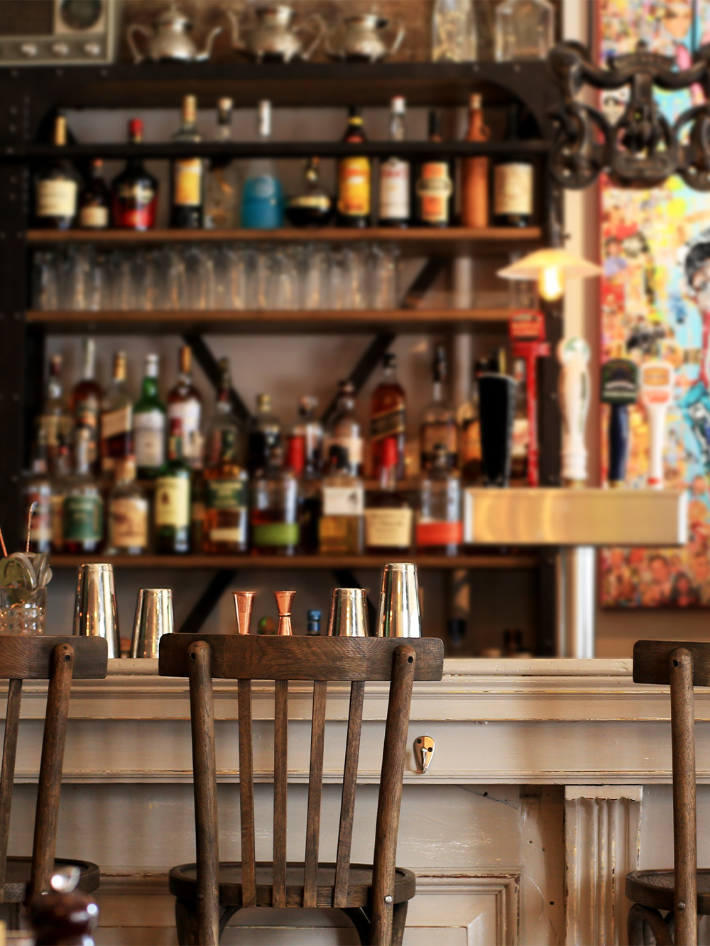 Bar counter with vintage decor and liquor bottles at American Prohibition Museum.