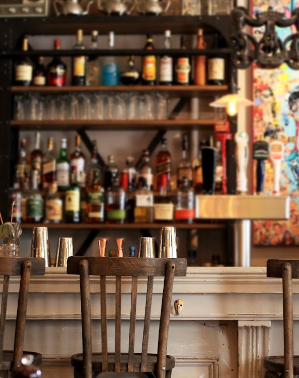 Bar counter with vintage decor and liquor bottles at American Prohibition Museum.