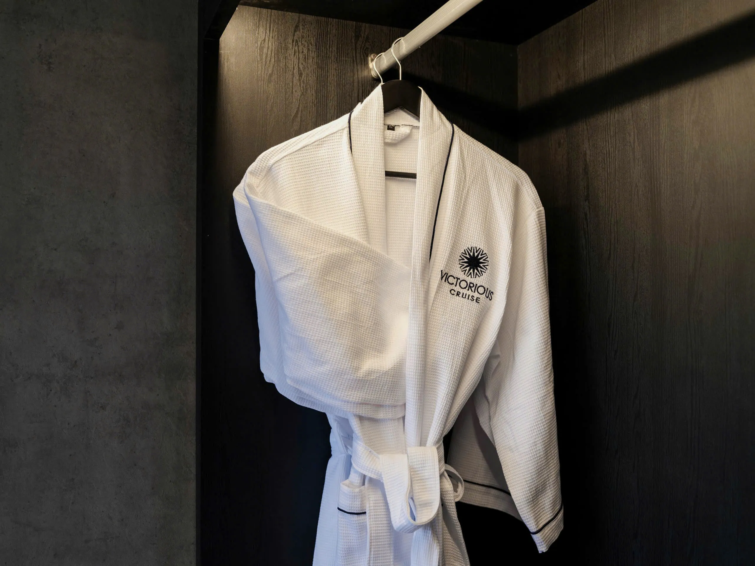 Luxury cruise robe hanging in a cabin closet, Halong Bay experience.
