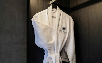 Luxury cruise robe hanging in a cabin closet, Halong Bay experience.