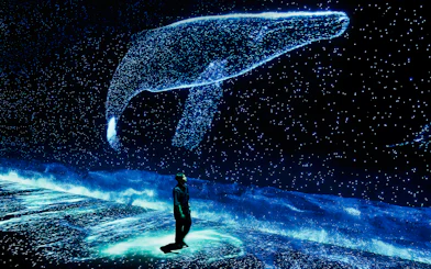 Visitor observing digital whale display at ARTE Museum.