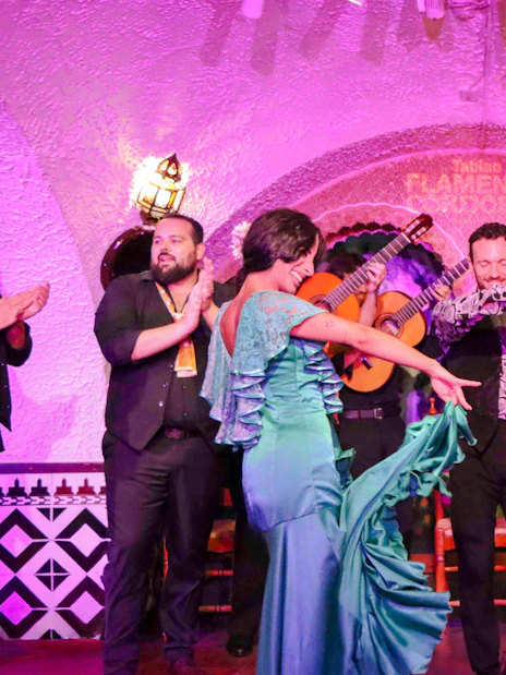 Flamenco dancers performing at Tablao Cordobes in vibrant costumes.