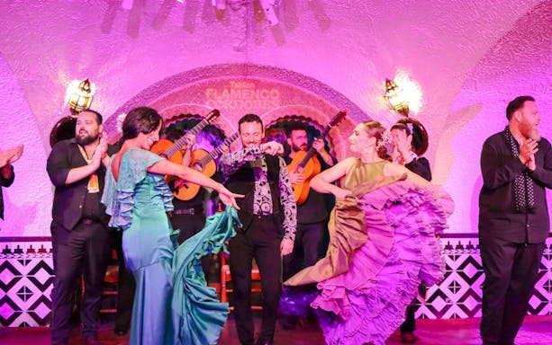 Flamenco dancers performing at Tablao Cordobes in vibrant costumes.