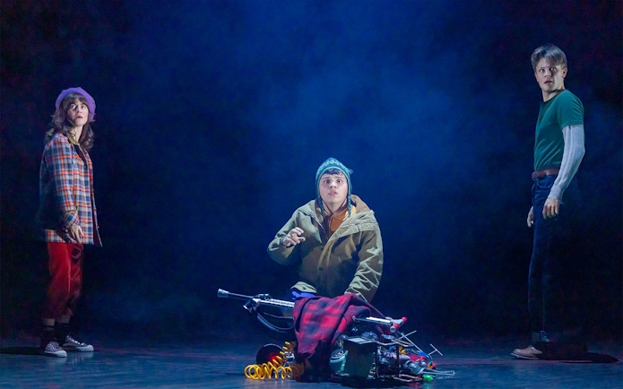 Three people in a dramatic scene from a Stranger Things stage production.