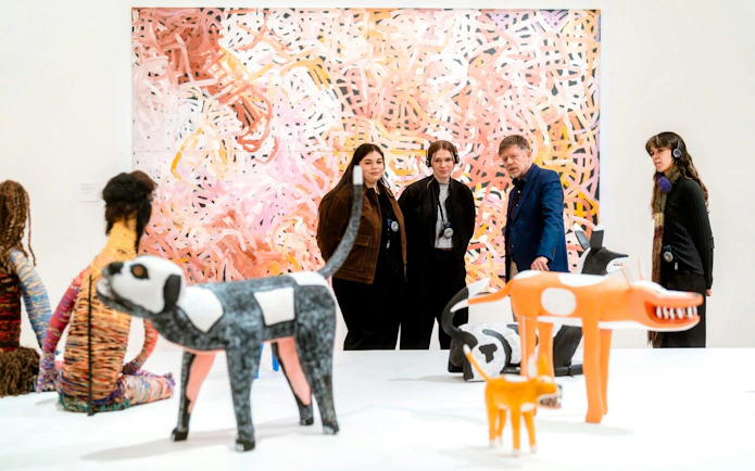 Visitors observing colorful sculptures and abstract art at the National Gallery of Victoria.